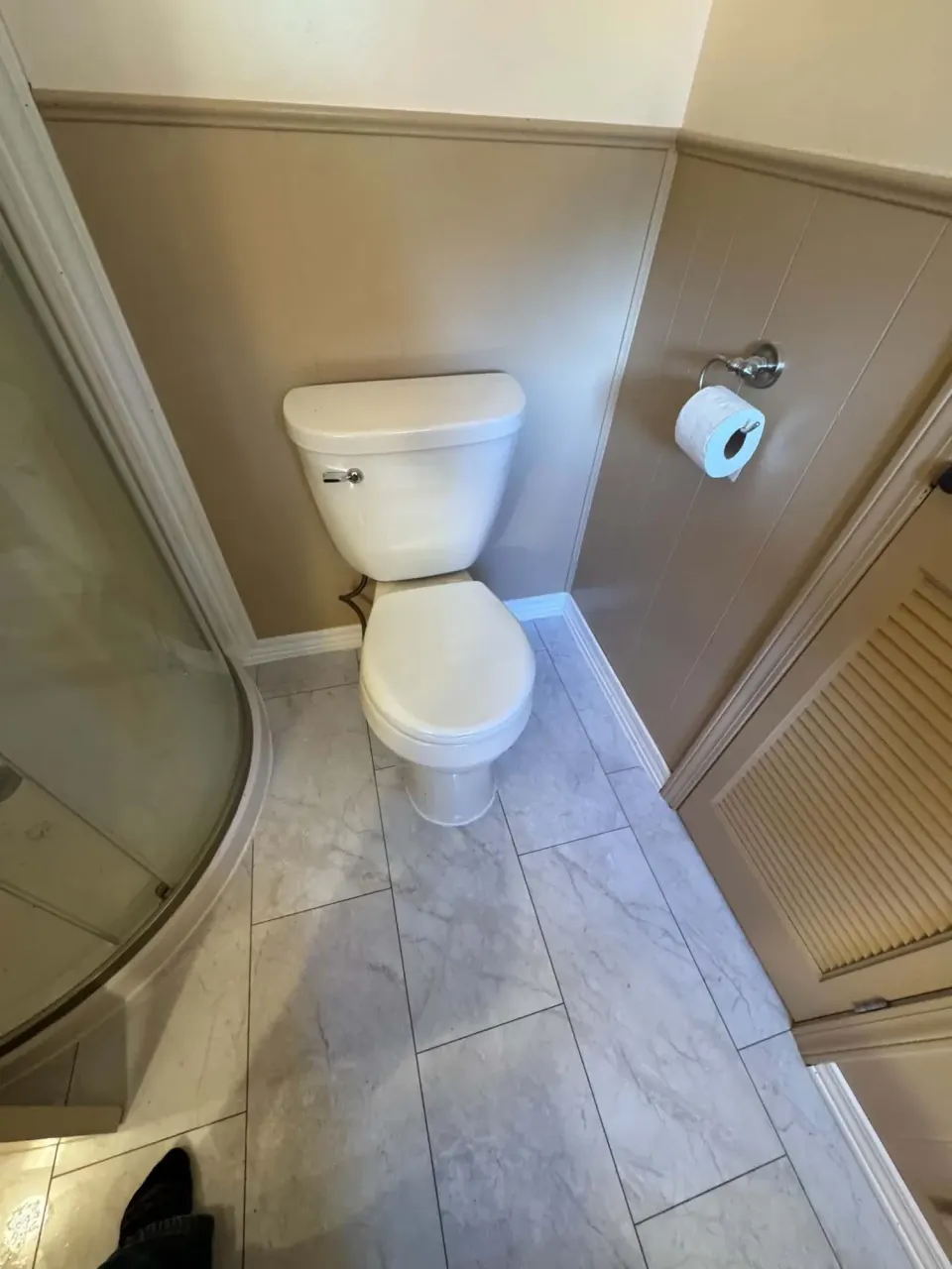 Bathroom with new marble-look vinyl tile floor and a reset toilet