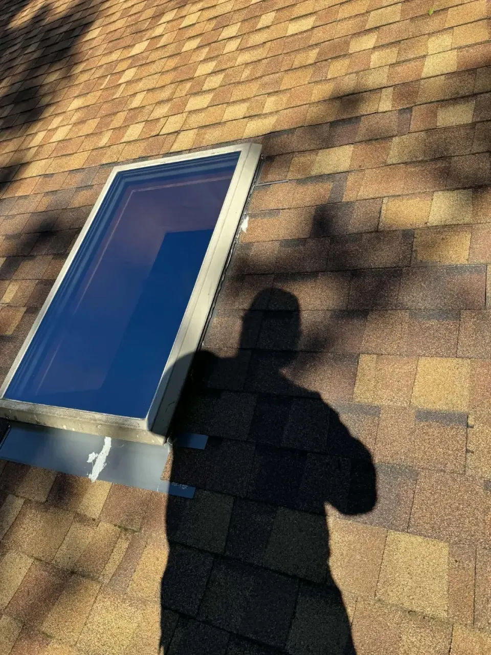 Skylight on a shingled roof with new metal flashing